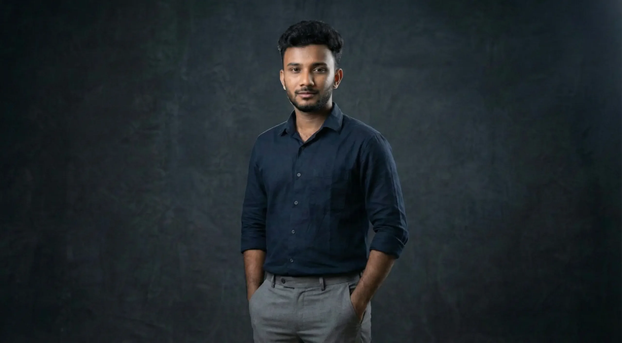 Vidhu Vinodhanan standing in a studio setting, representing expertise in SEO, content strategy, and AI-driven digital marketing